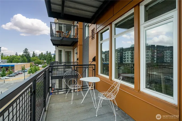 a view of a chairs and table in the balcony