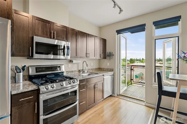 a kitchen with a stove a sink and a microwave