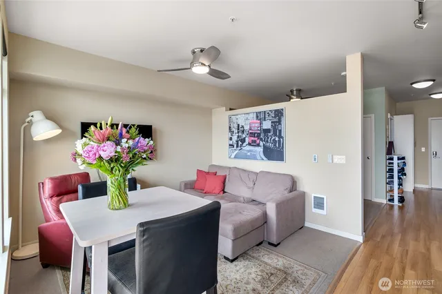 a living room with furniture and flowers