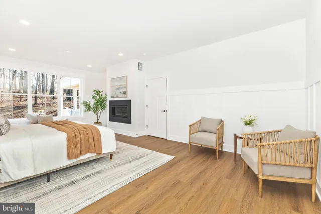 a view of an entryway with wooden floor and front door