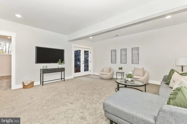 a front view of a house with yard and trees around