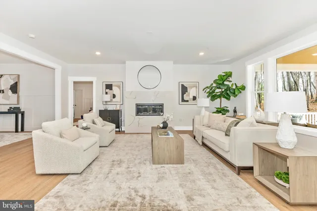 a kitchen with stainless steel appliances a dining table chairs stove and refrigerator