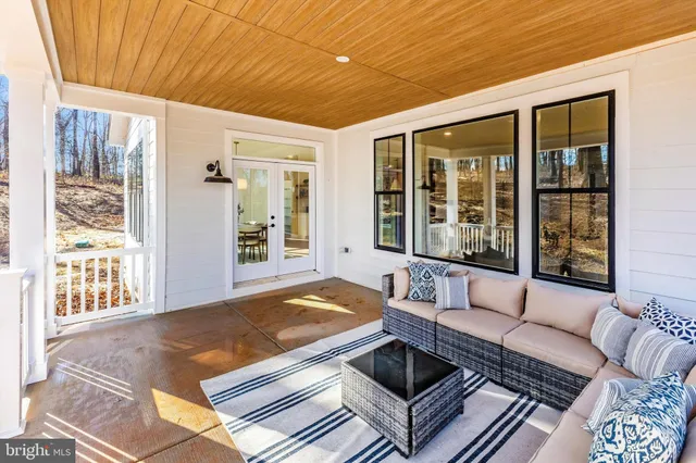 a front view of a house with a yard covered with snow