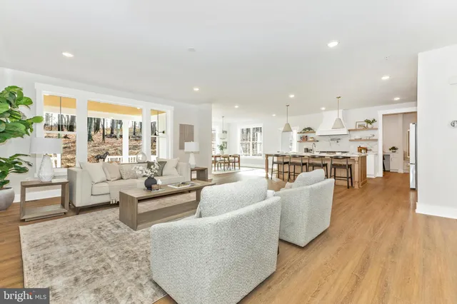 a living room with fireplace furniture and a wooden floor