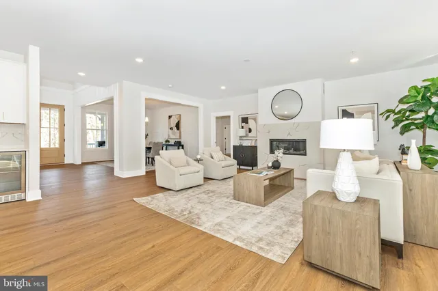 a living room with fireplace furniture and a wooden floor