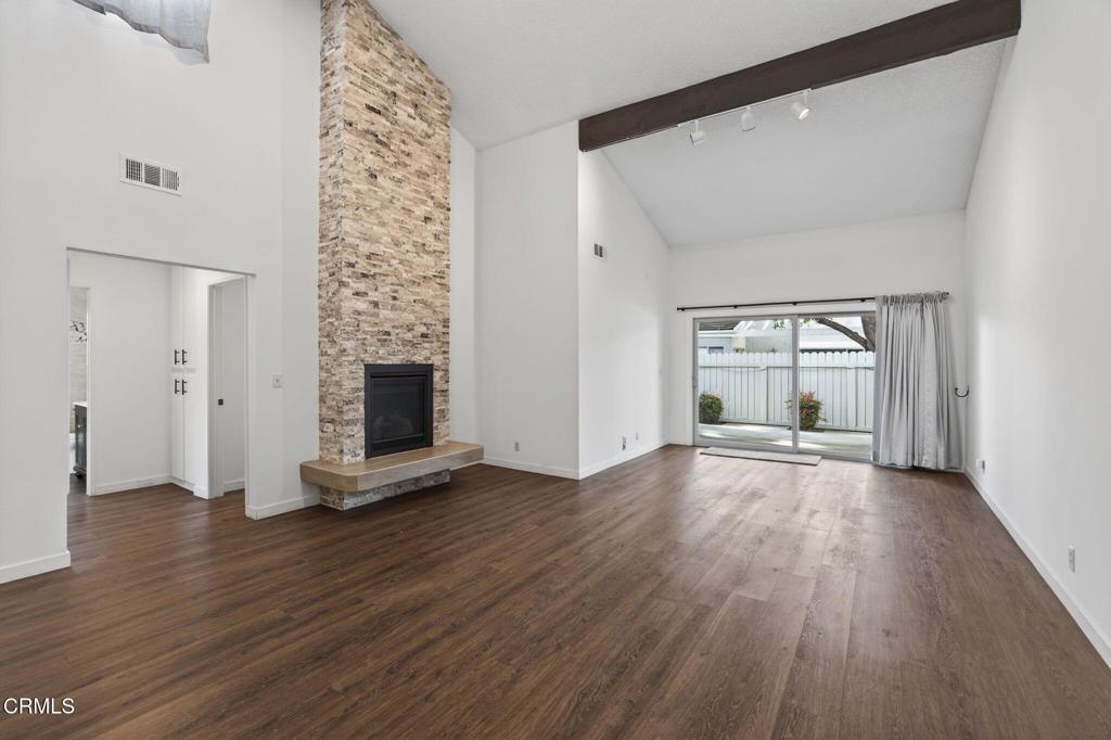 449 Reed Way Port Hueneme, CA 93041 - Photo 18 of 42 an empty room with wooden floor fireplace and windows