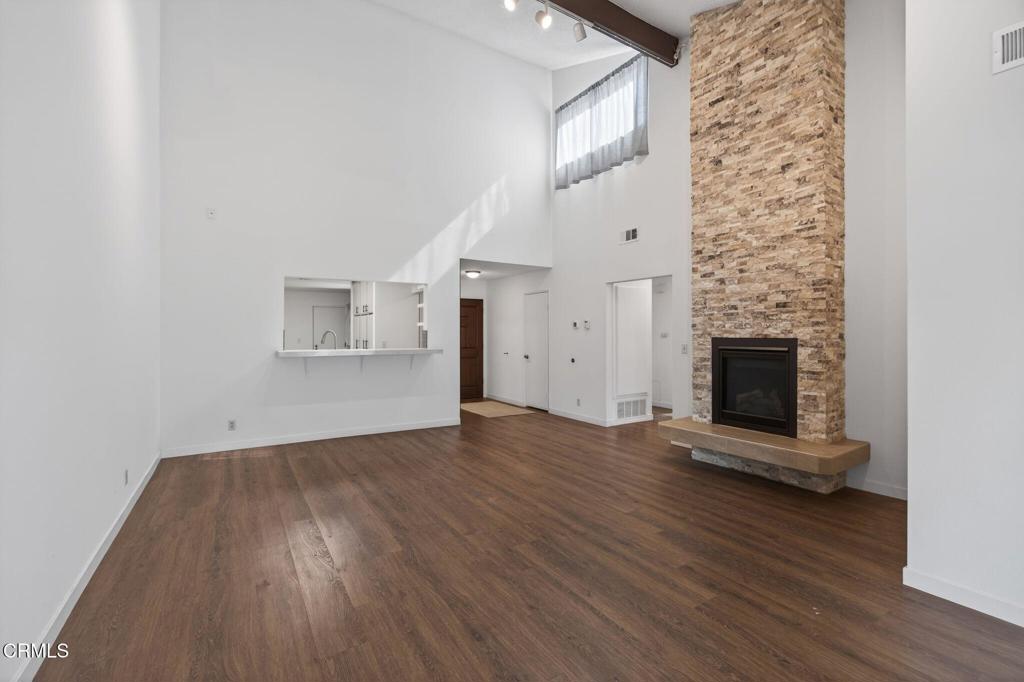 449 Reed Way Port Hueneme, CA 93041 - Photo 20 of 42 an empty room with wooden floor fireplace and windows