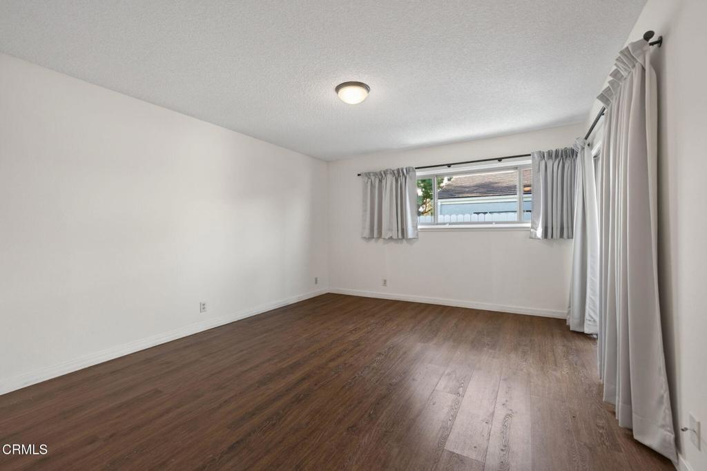 449 Reed Way Port Hueneme, CA 93041 - Photo 21 of 42 an empty room with wooden floor and windows