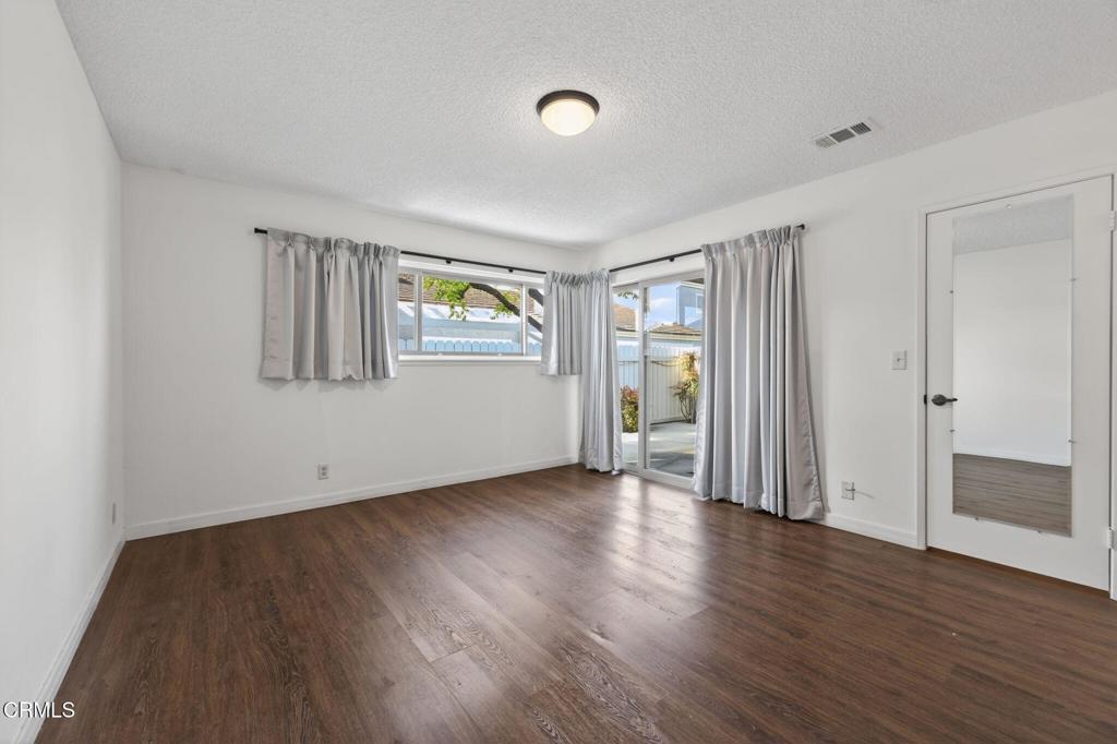 449 Reed Way Port Hueneme, CA 93041 - Photo 22 of 42 an empty room with wooden floor and windows