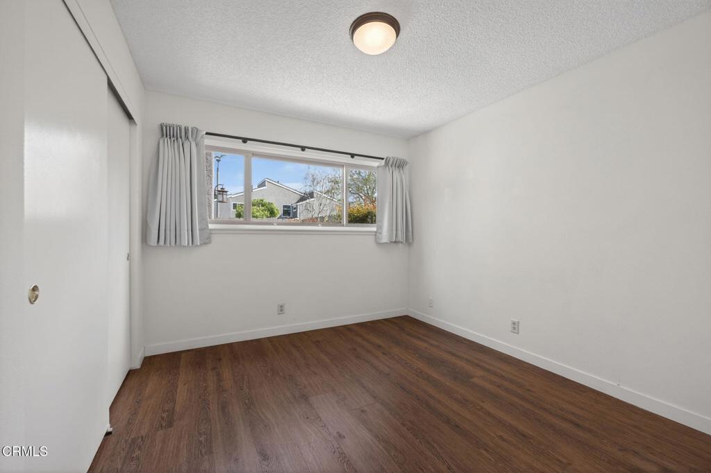 449 Reed Way Port Hueneme, CA 93041 - Photo 28 of 42 an empty room with wooden floor and window