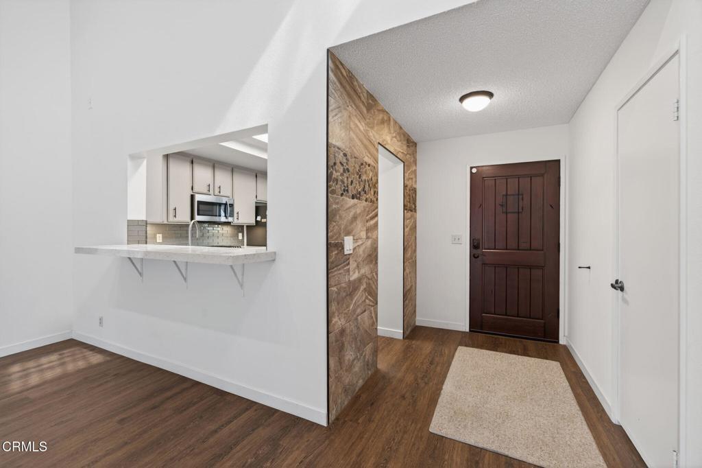 449 Reed Way Port Hueneme, CA 93041 - Photo 10 of 42 a view of a kitchen with wooden floor and a refrigerator