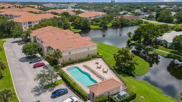 an aerial view of a house with garden space and lake view