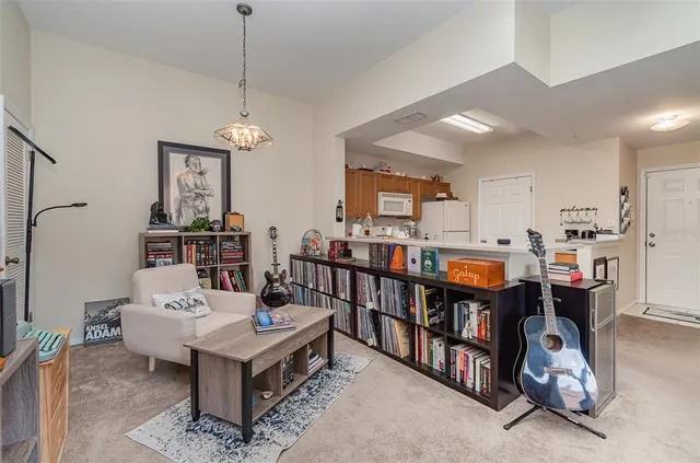 a living room with furniture a rug and a chandelier