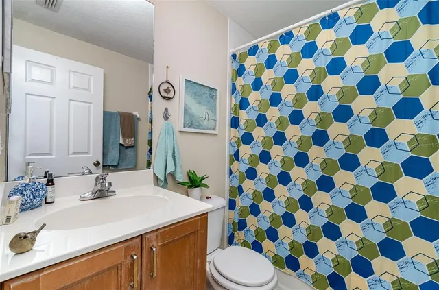 a bathroom with a sink and mirror with toilet