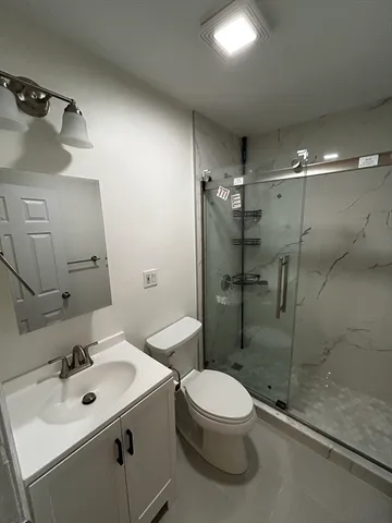 an empty room with wooden floor and mirror