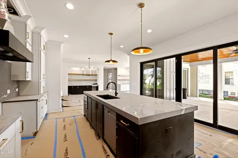 a kitchen with granite countertop a stove a sink and a microwave