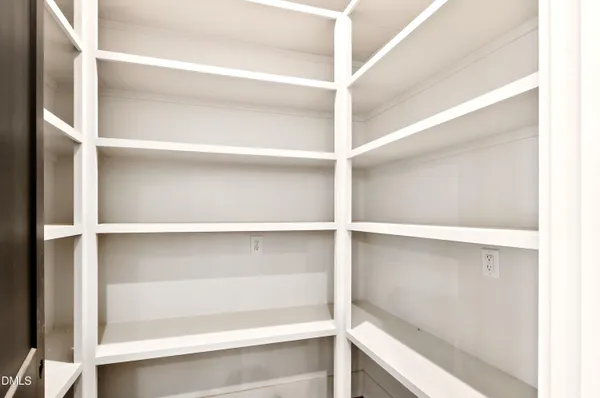 a spacious bathroom with a double vanity sink a large mirror a toilet a bathtub and window