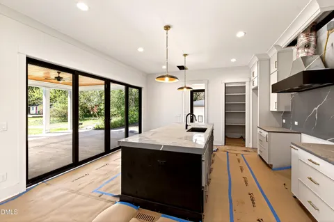 a kitchen with a stove sink and refrigerator