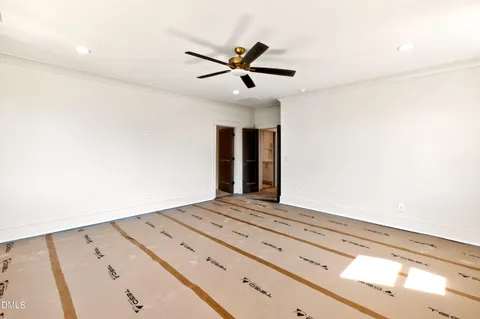 a spacious bathroom with a double vanity sink a large mirror a toilet a bathtub and window