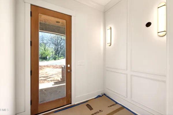 a view of a hallway with entryway and stairs