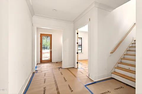 a view of a hallway with entryway and stairs