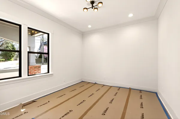 a view of a hallway with wooden floor and a kitchen