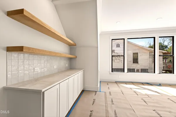 a kitchen with kitchen island granite countertop a sink and a stove