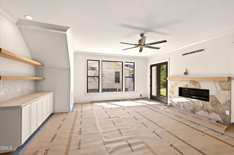 a living room with a flat screen tv fireplace and a fireplace