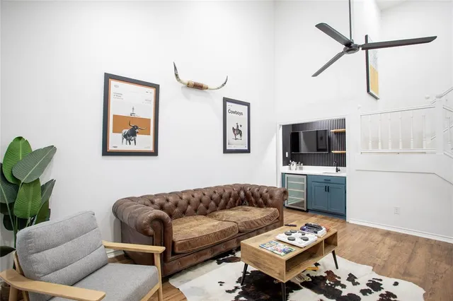 a living room with furniture a rug and a flat screen tv