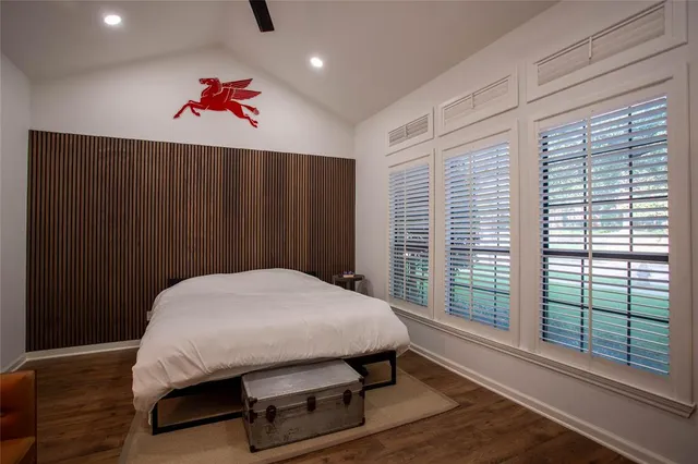 a bed sitting in a bedroom next to a window