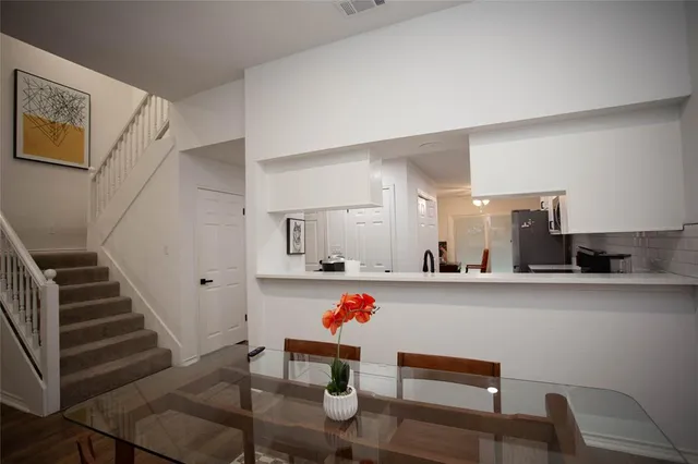 a living room with white furniture and wooden floors