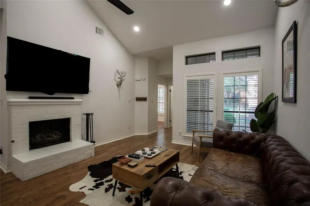 a living room with furniture a flat screen tv and a fireplace