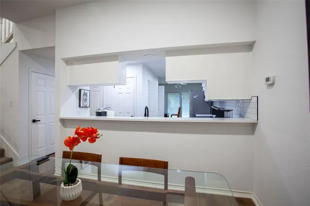 a living room with furniture and flower pot