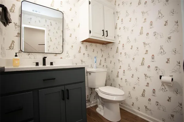 a bathroom with a toilet sink and mirror