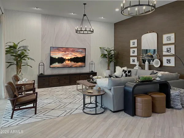 a living room with furniture a chandelier and a flat screen tv
