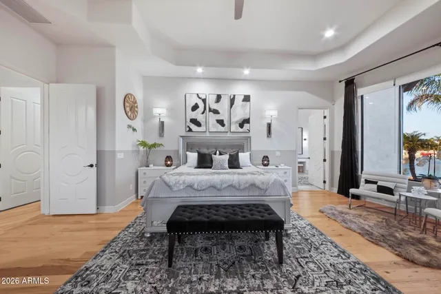 a bedroom with two beds and a large window