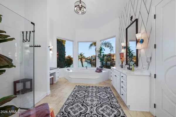 a spacious bathroom with a double vanity sink a mirror and shower