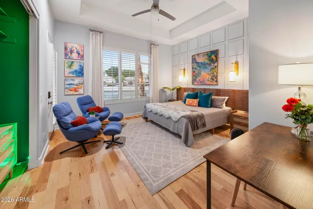 a bedroom with a bed and a painting on the wall