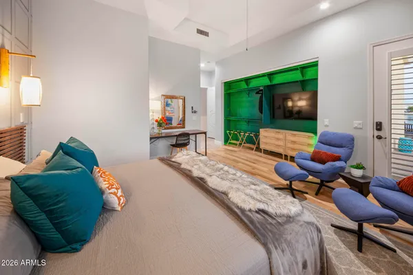 a bedroom with a large bed and a chandelier