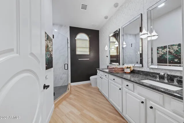 a bedroom with a large bed and a large window