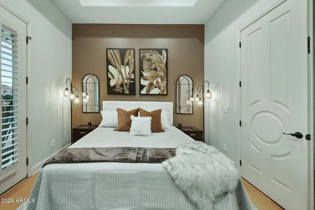 a bedroom with a large bed and a large window