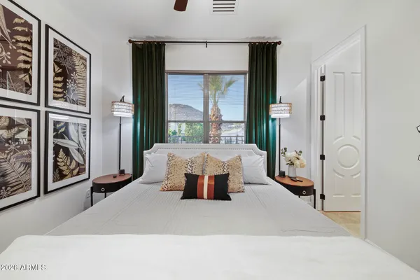 a view of a patio with a table and chairs under an umbrella