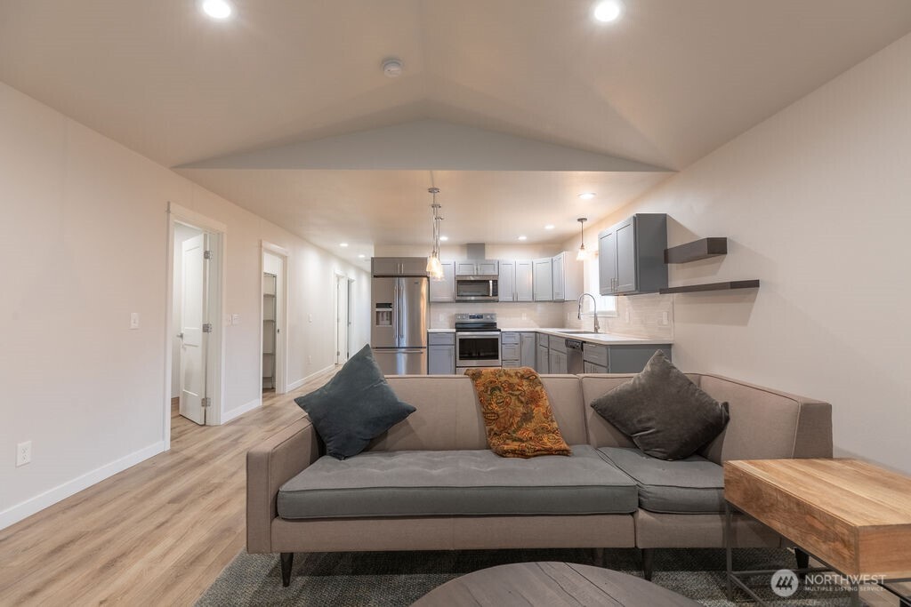 997 King Johns Way Forks, WA 98331 - Photo 17 of 39 a living room with furniture and kitchen view