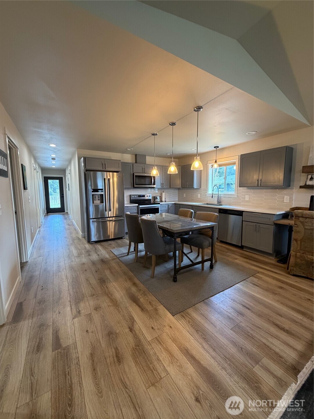 997 King Johns Way Forks, WA 98331 - Photo 4 of 39 a room with lots of wooden furniture a table and chairs in it