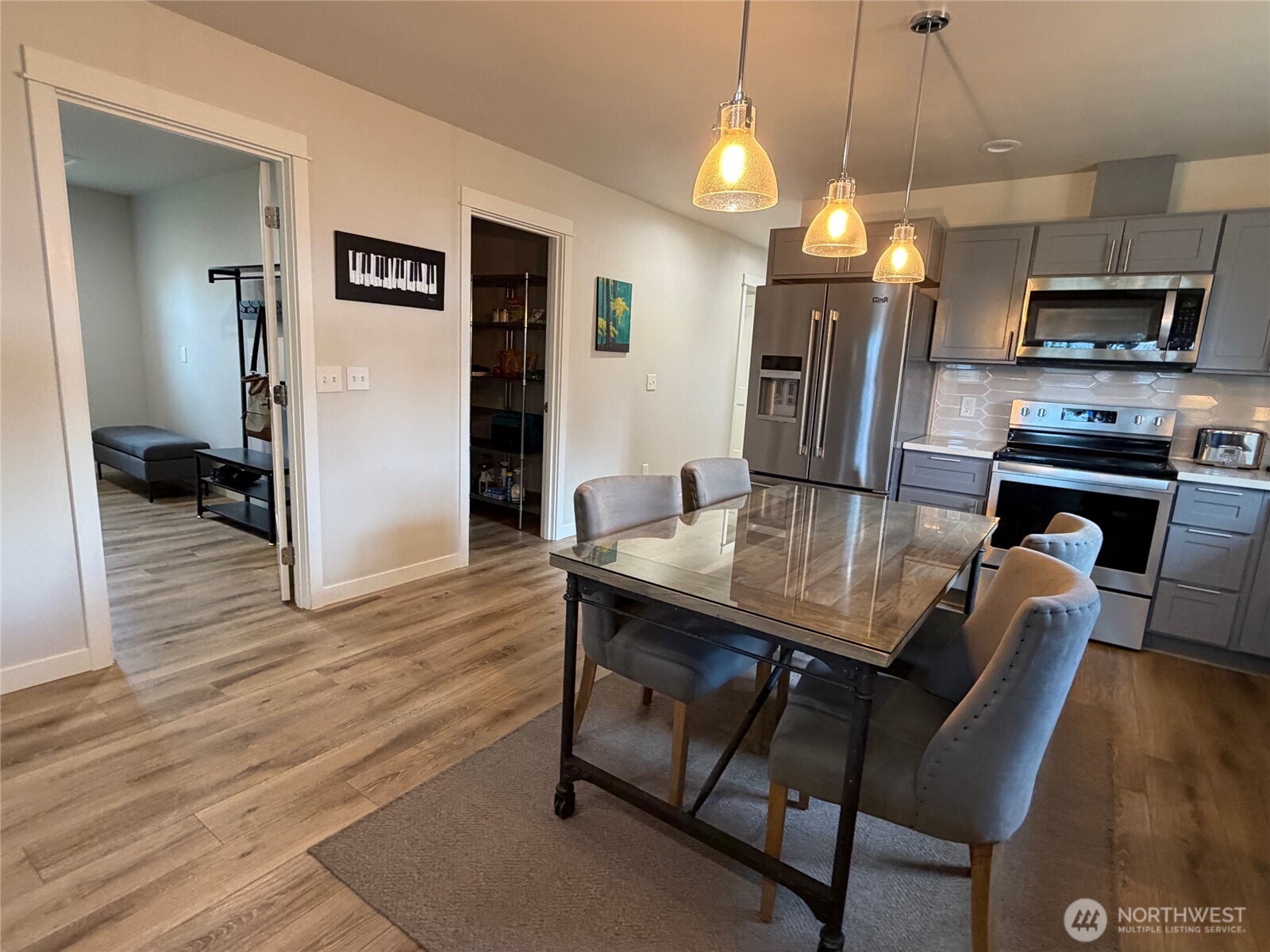 997 King Johns Way Forks, WA 98331 - Photo 5 of 39 a kitchen with granite countertop a table chairs microwave and refrigerator