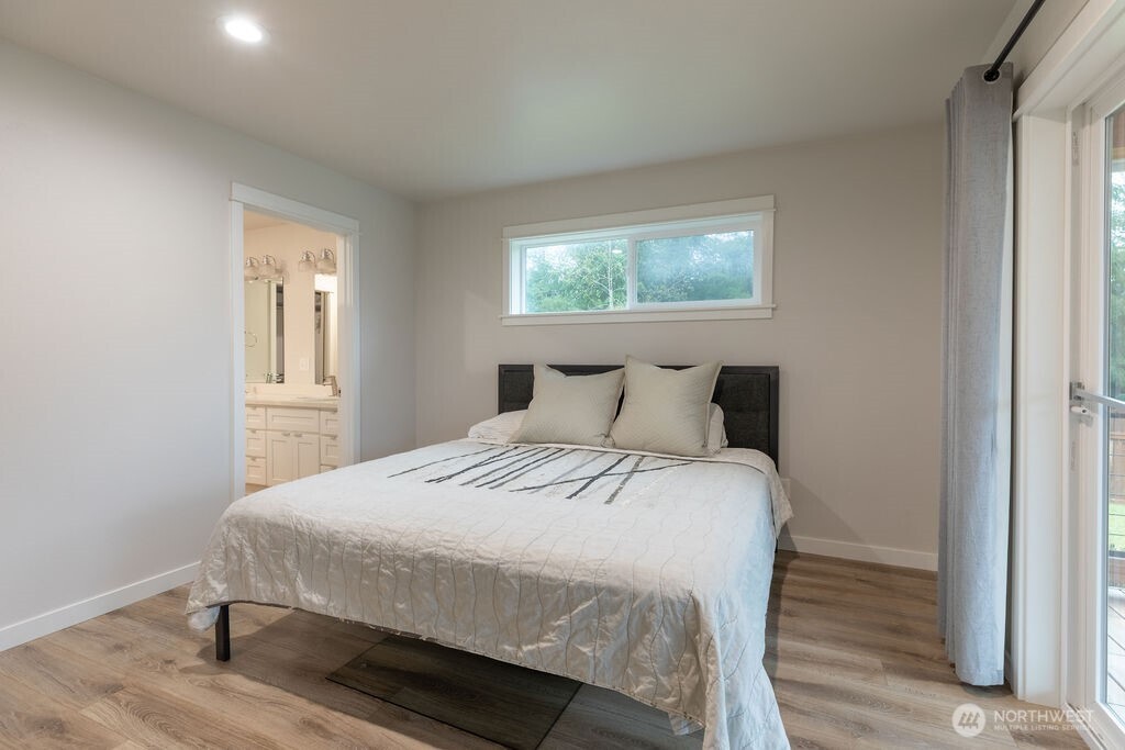 997 King Johns Way Forks, WA 98331 - Photo 7 of 39 a bedroom with a bed and wooden floor