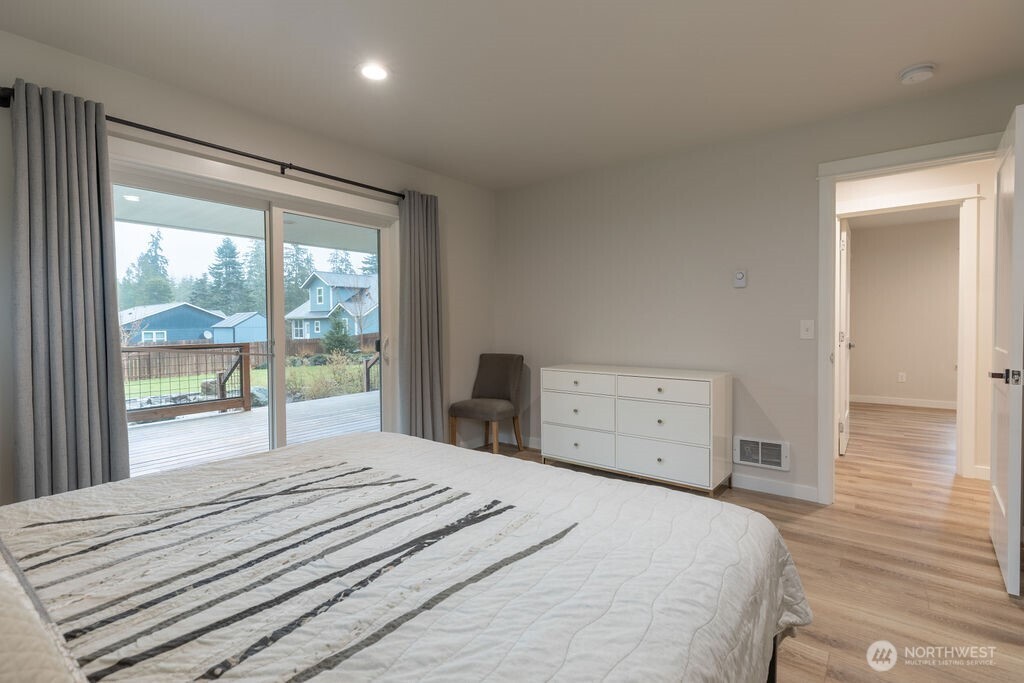 997 King Johns Way Forks, WA 98331 - Photo 8 of 39 a bedroom with a large bed and a large window