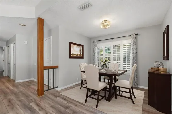 a dining room with furniture and window