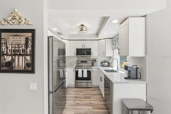 a kitchen with stainless steel appliances a stove microwave and a refrigerator