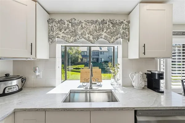a kitchen with a sink and cabinets